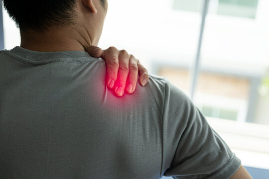 Close-up of shoulder pain from office syndrome, asian man touching neck and shoulders feeling body pain, importance of healthy spine, physical therapy concept