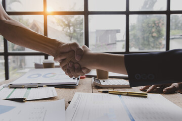 Business woman shaking hands and finishing up meeting at desk in office. © SOMKID