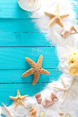 Summer background. Wooden background with white sand and seashells.Shells, starfish and sand. Holiday background