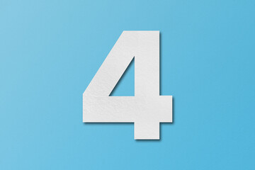 Obraz premium White paper type paper alphabet number 4 isolated on light blue background.
