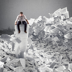 Businessman with paper sheet anywhere in office. Buried by bureaucracy concept. - obrazy, fototapety, plakaty
