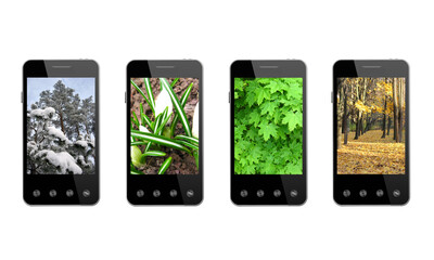 four smart-phones with colored images of seasons isolated on the white background