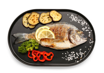 Tray with tasty grilled dorado fish with lemon and vegetables on white background