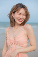 young slim beautiful woman on sunset beach, playful, summer vacation, sunny, having fun, positive mood, romantic, traveller, happy, Happy mixed race girl in casual outfit with wind in her hair.