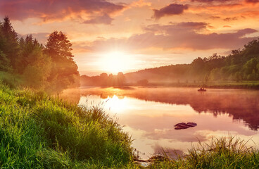 Landscape with sunset on the lake. Matutinal picturesque morning sky clouds in water sunbeam forest.