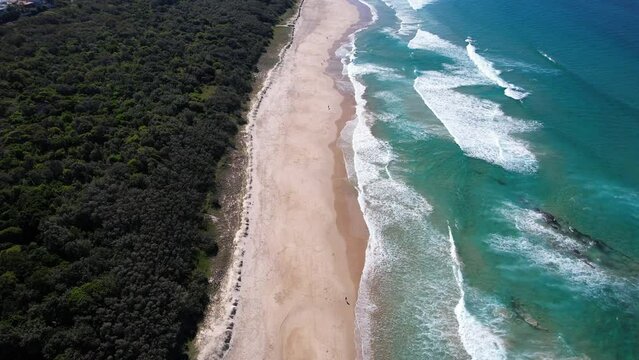 Coolum Beach With Turquoise Ocean And Lush Vegetation In Queensland, Australia - aerial drone shot