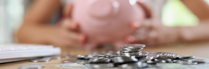 Pile of coins and banknotes, piggy bank