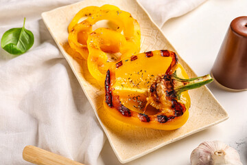 Plate with tasty grilled bell  peppers on table