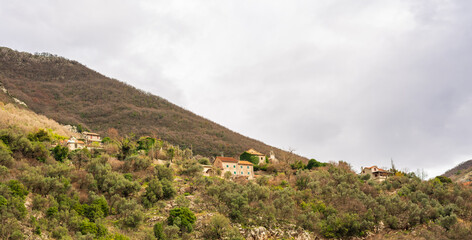 Mountain village with tiled roofs in the Bay of Kotor. Trekking in spring.