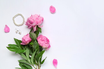 Composition with stylish female accessories and beautiful peony flowers isolated on white background