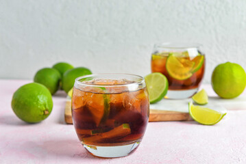 Glass of cold Cuba Libre cocktail on table