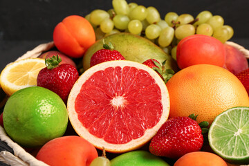 Fototapeta na wymiar Bowl with different fresh fruits, closeup