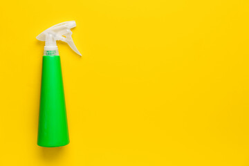 Sprayer bottle with detergent on orange background