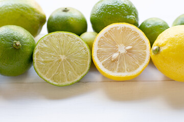Ripe lemons and limes on white.