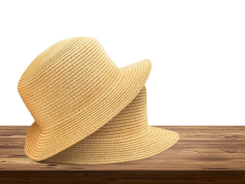 Two vintage straw hats lie on wooden table PNG transparent