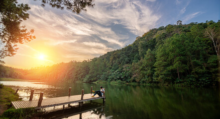 Traveller wiht tablet is relax in Pang Ung Lake ,North of Thailand