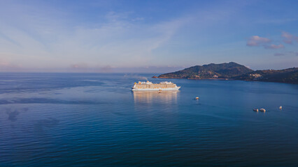 Drone Camera Aerial view of Patong town in Phuket, Thailand. The sea is beautiful in the summer, the sun is shining, the morning is comfortable.
