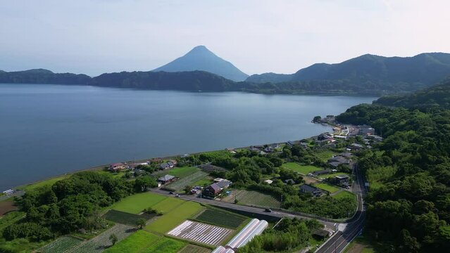 Aerial drone footage of the Kaimon volcano and the rural landscape around the lake Ikeda in Kyushu in Japan