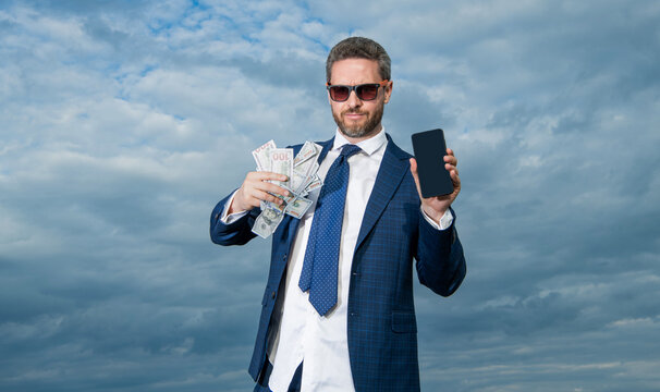 betting man with lottery money hold phone. photo of betting man with lottery money.
