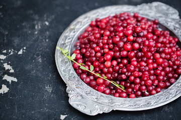 Sweet fragrant cranberries on a silver plate