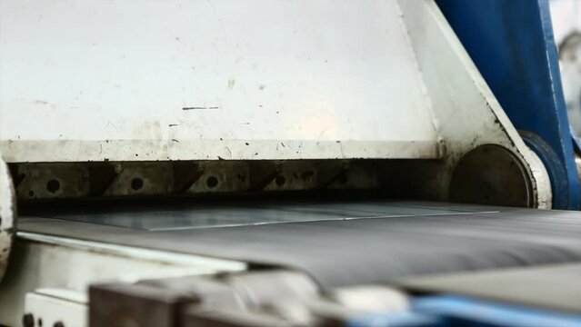 Metal or steel sheet cutting in a automated cutting machine in factory.