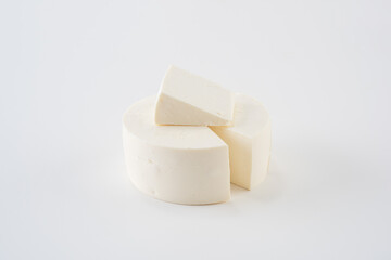 Pie and breakfast cheese cut into circles and sliced. On a white background.