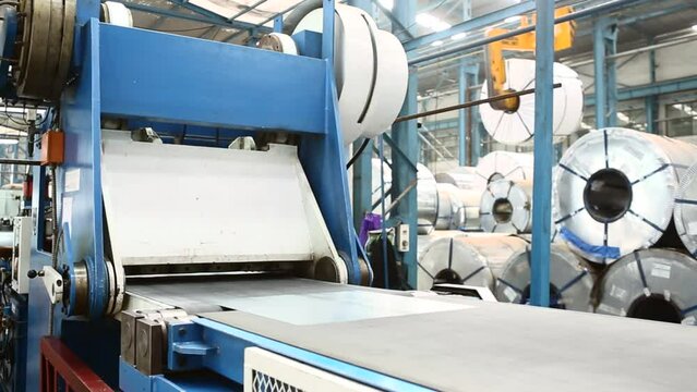 Metal or steel sheet cutting in a automated cutting machine in factory.