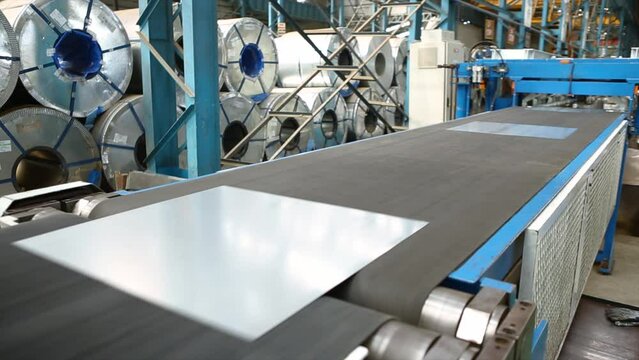 Metal or steel sheet cutting in a automated cutting machine in factory.