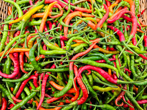 The Red and green chili background, Fresh Green And Red hot chilli peppers © Chatchaa
