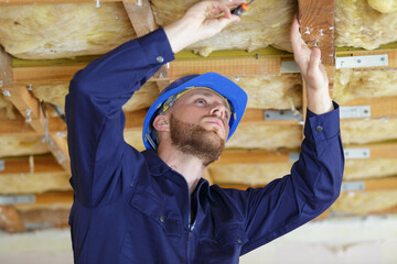 a man is fixing something on the ceiling