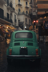 Fototapeta na wymiar Old vintage car on the streets of Italy Amalfi coast rainy day moody