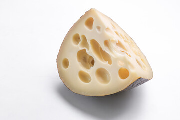 Emmental cheese triangle, Swiss cheese, isolated on white background. High resolution image