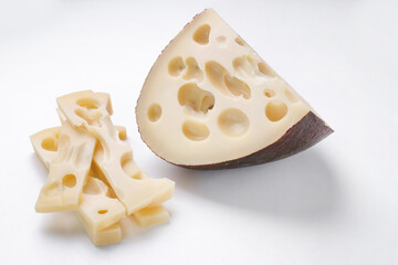 Emmental cheese triangle, Swiss cheese, isolated on white background. High resolution image