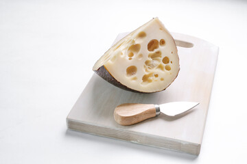 Emmental cheese triangle, Swiss cheese, isolated on white background. High resolution image