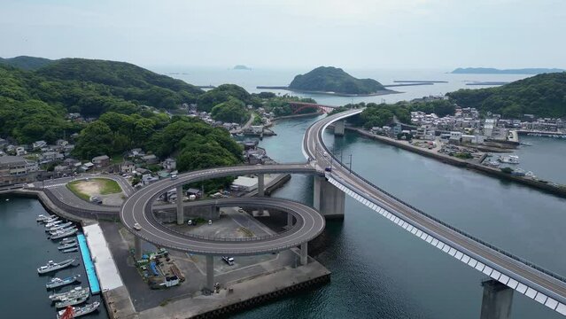 Ushibuka, Japan: Aerial forward drone footage of the Haiya Bridge in the Amakusa island in kyushu in Japan on a overcast spring cold day