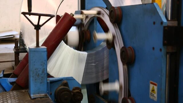 Coil wrap in a automated wrapping machine. metal coil reel plastic wrapping for transportation and protection from scratch. 