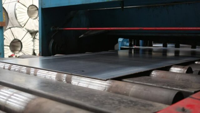 Metal or steel sheet cutting in a automated cutting machine in factory.