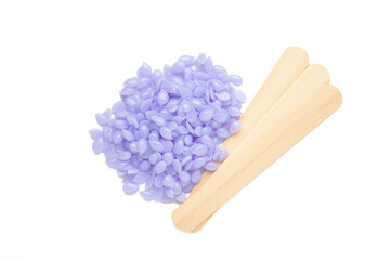 Sticks of wood for wax and spa with wax granules isolated on white background