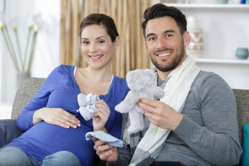 future parents holding gifts for unborn baby