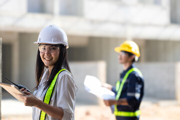 Progressive Construction Project Management with Engineers and Tablets - Blueprint Planning and On-Site Expertise