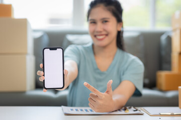 Delivery app. Close-up of smiling young woman in hand showing smartphone with blank screen for...