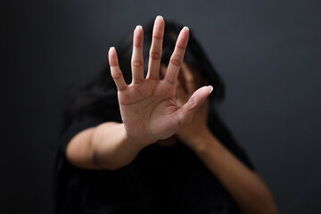 Fototapeta premium International Human Right day Concept. Women with her hand extended signaling to stop useful to campaign against violence, gender or sexual discrimination