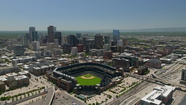 Downtown Denver Coors field Colorado Rockies baseball stadium Rocky Mountain landscape Mount Evans aerial drone cinematic foothills Colorado cars traffic spring summer circling left