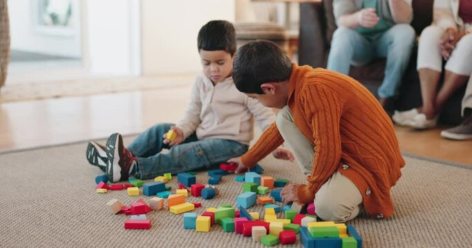 Children, toys and playing together in a family home for development, learning and bonding. Boys, siblings or kids on a carpet on living room floor to play with building blocks for education and fun