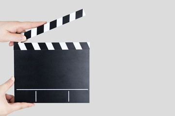 A hand holding a slate bar. gray background