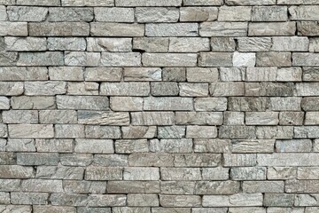 Gray stone brick wall. Background and texture, full frame.