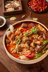 Beef and tomato noodles on wooden tabletop, indoor shot,Traditional Chinese Noodles