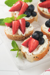 American flag sandwich with strawberries, blueberries, whipped sweet cream, soft cheese on toast bread. 4th of July American Independence Day food. Independence or Patriotic Day breakfast idea Mock up