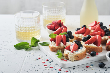 American flag sandwich with strawberries, blueberries, whipped sweet cream, soft cheese on toast bread. 4th of July American Independence Day food. Independence or Patriotic Day breakfast idea Mock up