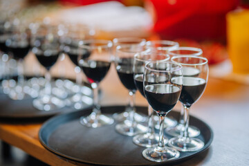 wine glasses on a waiters tray. Tray with glasses of alcohol drink